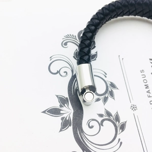 Punk rock men's black braided leather skull bracelet with a polished silver magnetic clasp