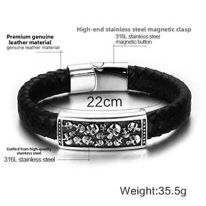 Detailed view of skull embossed stainless steel plaque on black leather woven bracelet