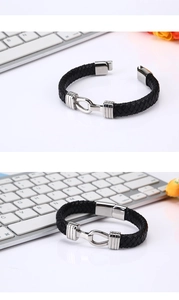Detail of black woven leather bracelet showing polished silver stainless steel hook clasp