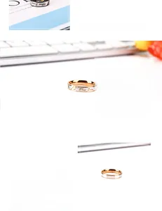 Detail view of True Love engraved titanium steel couple rings with zircon stone inlays