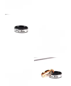 Macro detail of titanium steel rings featuring hollow design and True Love engraving