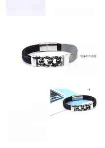 Detail view of men's black braided leather bracelet with stainless steel skull magnetic clasp