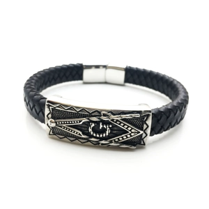 Detail of braided leather bracelet featuring a silver Masonic emblem and magnetic clasp