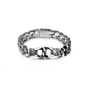 Detail shot of vintage silver stainless steel chain bracelet with ornate engraved links