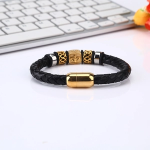 Men's woven leather bracelet featuring gold fleur-de-lis beads and magnetic clasp