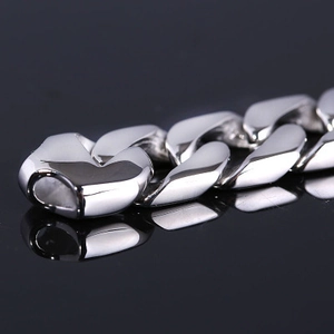 Polished silver titanium steel Cuban link bracelet for men with mirror finish reflection
