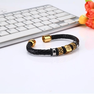 Men's black braided leather bracelet with gold iris charm and C-shaped opening design