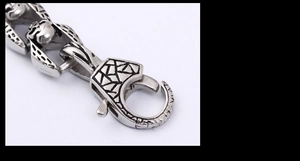 Macro detail of gothic skull link and spring clasp on vintage stainless steel bracelet