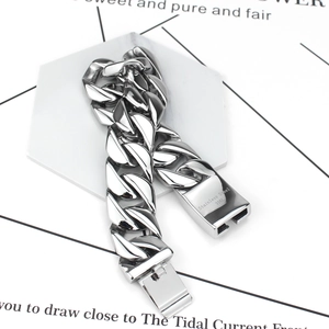 Mens silver 316L stainless steel Cuban chain bracelet on a hexagonal display stand