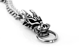 Macro detail of silver dragon head bracelet with vintage finish and polished ring clasp