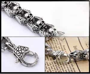Detail view of gothic skull links and engraved lobster clasp on stainless steel bracelet