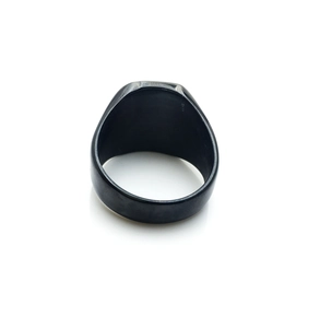 Minimalist matte black titanium steel signet ring for men shown from a top-down angle