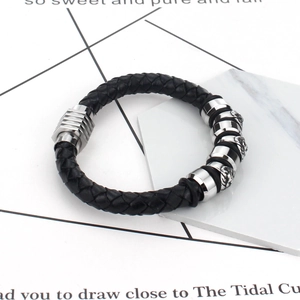 Men's black braided leather bracelet with silver lion head charms and magnetic clasp
