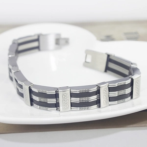 Detail of men's wide silicone and titanium steel bracelet with polished metal links