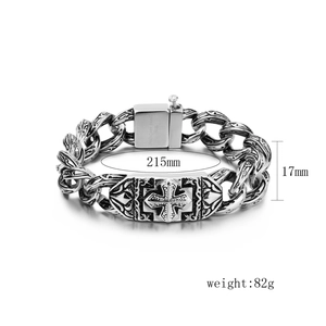 Macro detail of retro engraved stainless steel links and cross plaque on silver bracelet