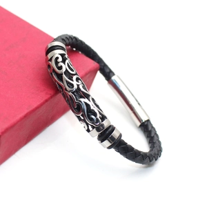 Men's black braided leather bracelet with hollow silver metal charm on a red gift box