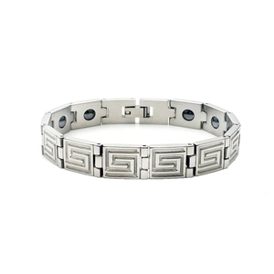Detail showing titanium steel bracelet with Greek key pattern and magnetic therapy stones