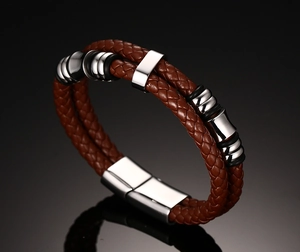 Macro shot of double-layer brown leather braided bracelet with magnetic metal clasp