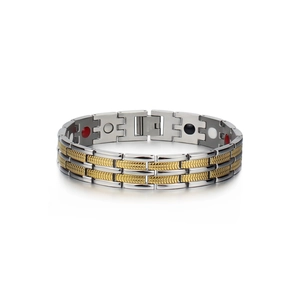 Macro detail of men's two-tone magnetic therapy bracelet with gold link inlays