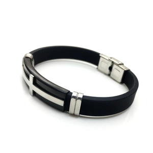 Detail of black silicone men's bracelet with stainless steel cross inlay and buckle