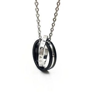 Macro detail of interlocking rings pendant with LOVE engraving and zircon crystals