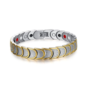 Detail of men's stainless steel magnetic bracelet with hammered texture and two-tone gold finish