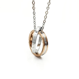 Macro detail of intertwined silver and rose gold rings with Love engraving and diamonds