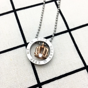 Detail of crown pendant necklace with Keep Me In Your Heart engraving and zircon stone