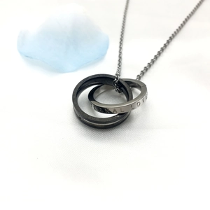 Detail of interlocking silver and black rings with Eternal Love engraving and crystals