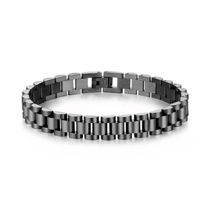 Macro detail of gunmetal stainless steel link bracelet with watch strap style engraving