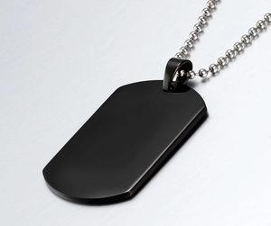 Macro shot of matte black stainless steel dog tag pendant with silver ball chain