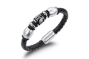 Detail of black braided leather bracelet with retro totem metal beads and magnetic clasp