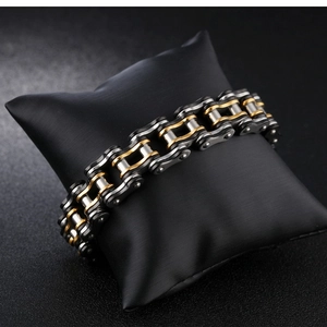 Detail of bike chain style bracelet in black silver and gold stainless steel links