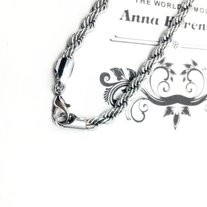 Polished stainless steel rope chain bracelet with secure lobster clasp on minimalist card