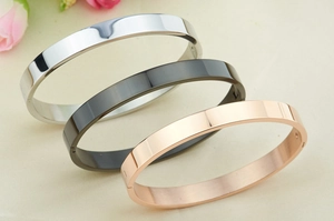 Polished silver, black, and rose gold stainless steel bracelets with snap closure