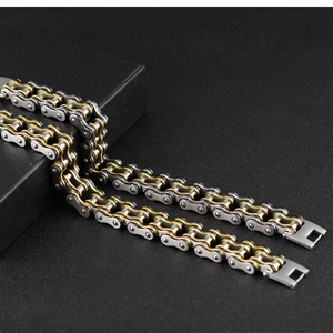Detailed view of bicolor silver and gold stainless steel motorcycle chain bracelet