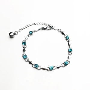 Silver bracelet with blue cubic zirconia rhinestones and a bell charm for women