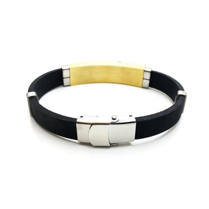 Detail of men's silicone bracelet with gold curved metal plate and silver clasp buckle