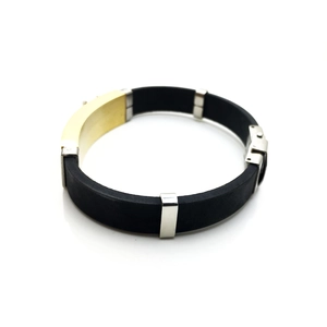 Close-up of matte black silicone band with gold and silver stainless steel buckles