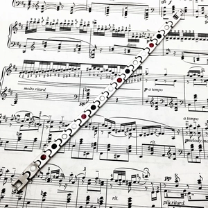 Polished titanium steel magnetic therapy bracelet with wave links on musical sheet