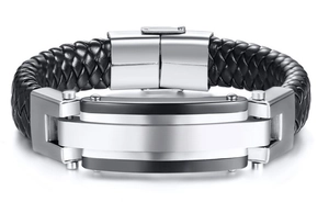 Macro detail of men's black braided leather bracelet with stainless steel clasp and metal inlay
