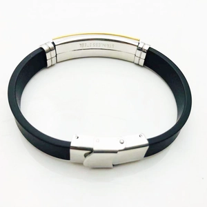 Close-up of stainless steel clasp and engraved metal buckle on black silicone bracelet