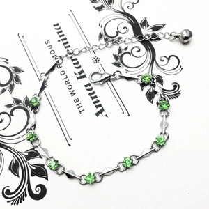 Detail of silver bracelet with green cubic zirconia, lobster clasp and extension chain