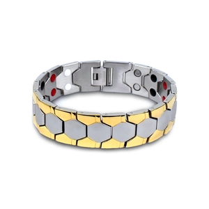 Macro detail of men's magnetic steel bracelet with bicolor links and functional therapy stones