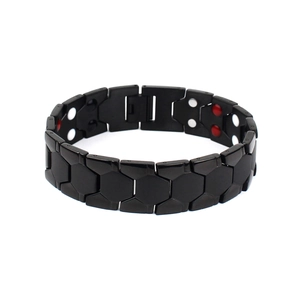Macro detail of men's titanium steel magnetic therapy bracelet with inset health stones