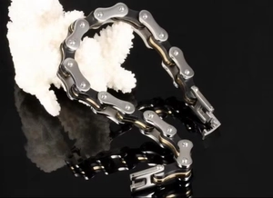 Macro view of mechanical bicycle chain bracelet with silver and black steel links