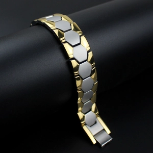 Detail of masculine two-tone gold and silver hexagonal link bracelet with magnetic clasp