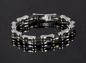 Detail view of bicycle chain design bracelet in silver, black and gold stainless steel