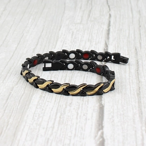 Women's magnetic titanium steel therapy bracelet in black and gold wave pattern