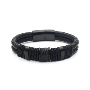 Detail of men's black braided leather bracelet with magnetic clasp and metal accents
